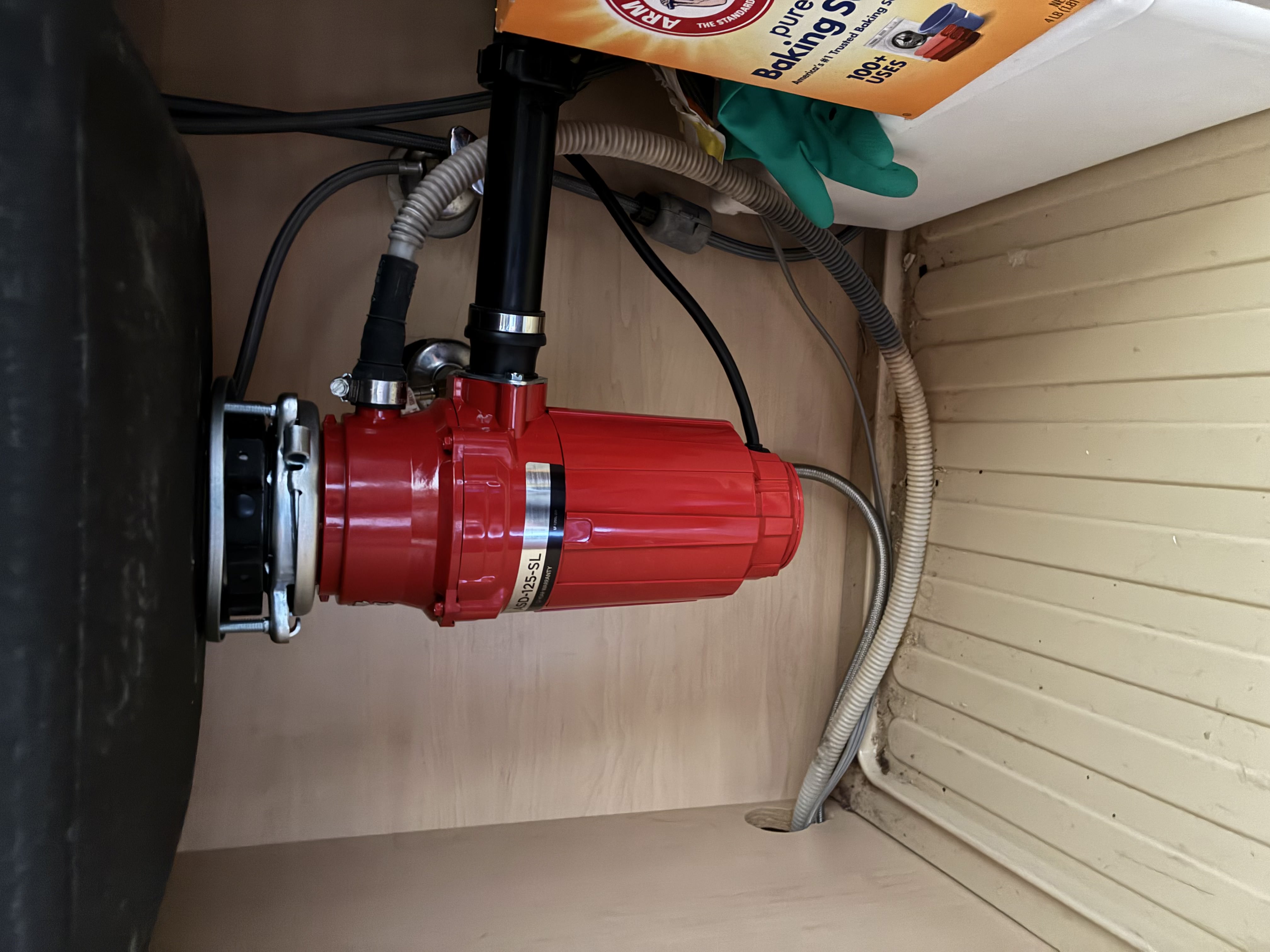 Garbage disposal installation under a kitchen sink